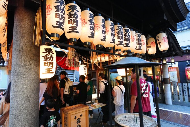 Osaka 4-Hour Walking Tour: Hotspots and Hidden Gems - Dōtonbori neon and the lantern-lit switch at Hōzenji Temple