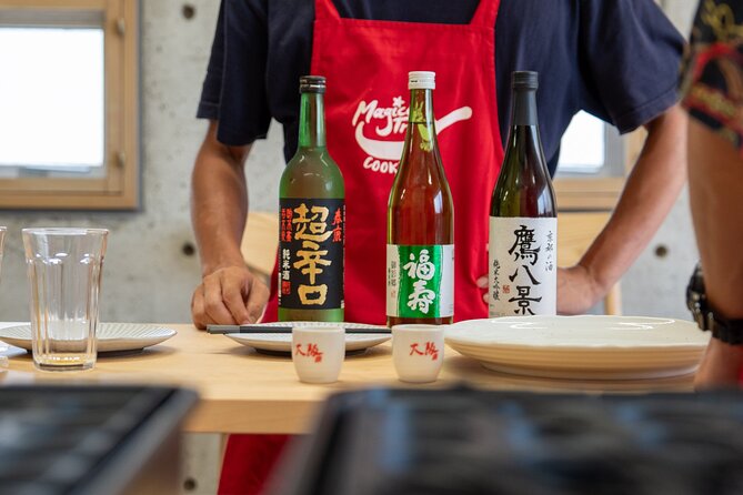Osaka Home Feast Cooking and Sake Experience - The cooking studio setup: aprons on, pans ready