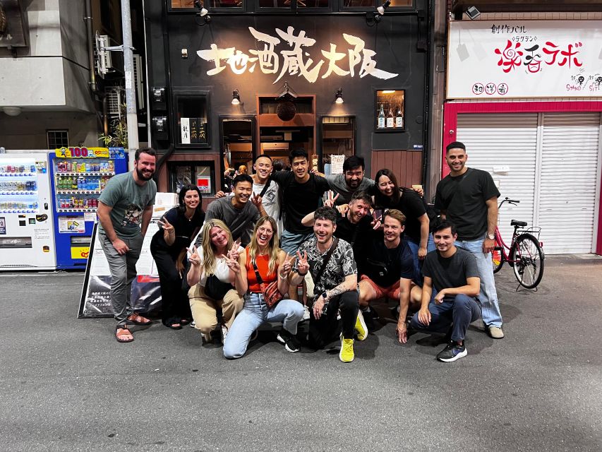 Osaka: Izakaya Bars Guided Walking Tour - Dotombori Humanity Song Monument: the Glico sign start that gets you moving
