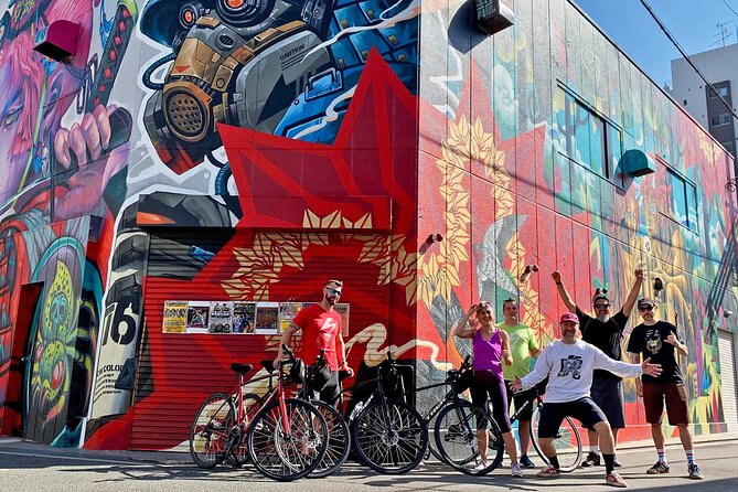 Urban Canvas: Osaka Street Art Bike Tour - Tenma on a bike: backstreets, a hip local stand, and quick food tips